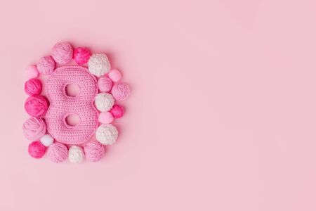 8 March symbol. Figure of "eight" made of handmade crochet. Happy womans day design. Decorative greeting grungy hobby card or postcard for international Woman's Day on 8 March. Birthday for girlの写真素材