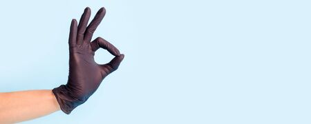 Female hand in cosmetology medicine black gloveの写真素材