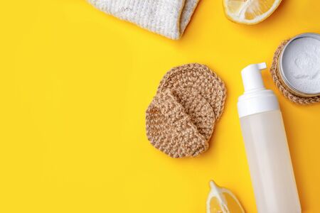 Set of eco-friendly natural cleaning products on yellow kitchen table: soda, essential oils, cellulose sponge, rags, lemon, soap, vinegar. Zero waste, eclogical habbitsの写真素材