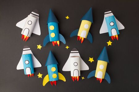 Set of spaceship, shuttle, rocket on black background with copy space for text. Concept of business launch, start up, handcraft, diy, creative idea from toilet tube, recycleの写真素材