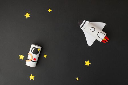 Spaceship, shuttle, rocket and astronaut on black background with copy space for text. Concept of business launch, start up, handcraft, diy, creative idea from toilet tube, recycleの写真素材