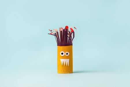 Antistress art therapy for kids, coronavirus pandemic, monsters for Halloween party. Easy crafts for kids on blue background, copy space, diy creative idea from toilet tube, recycle conceptの写真素材