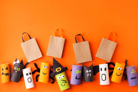 Happy halloween holiday concept. Halloween decorations monsters on orange background. Halloween party greeting card mockup with copy space. Flat lay, top view, overhead, easy papercraft diyの写真素材