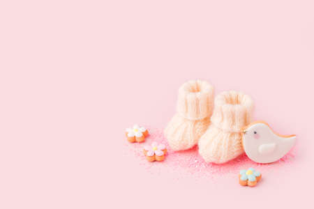 Pregnancy motherhood perenthood concept, Three pairs of baby booties on pink background, baby...
