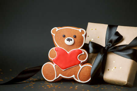 Stylish papercraft gift box and cookies bear with red heart, Concept of seasonal february Saint...