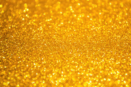 Gold background glitter christmas texture abstract light glittering stars on bokeh. glitter vintage...