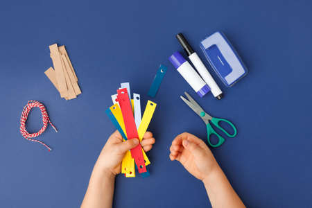 Making of handmade christmas garland from colorful paper with your own hands. Children's DIY concept. Making xmas tree or home decoration. Step 2. Saty home activitiesの写真素材