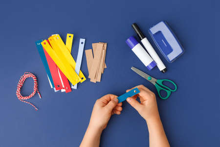 Making of handmade christmas garland from colorful paper with your own hands. Children's DIY concept. Making xmas tree or home decoration. Step 3. Saty home activitiesの写真素材