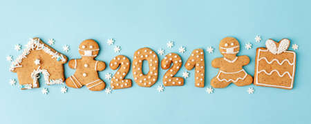 Happy New Year's set of numbers 2021, gingerbread man in face mask from ginger biscuits glazed sugar...