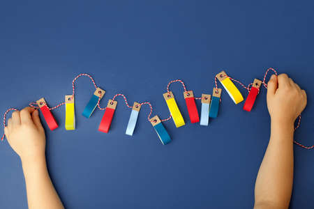 Making of handmade christmas garland from colorful paper with your own hands. Children's DIY...