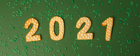 Winter Holiday banner- set of gingerbread on natural green background - Number Happy New Year 2021 and xmas tree sprinkles, Merry Christmas background, trendy concept, flyer, invitationの写真素材