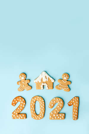 Happy New Year's set of numbers 2021, gingerbread man in face mask from ginger biscuits glazed sugar...