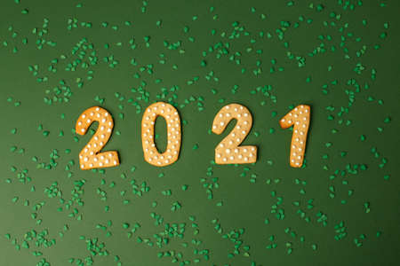 Winter Holiday banner- set of gingerbread on natural green background - Number Happy New Year 2021 and xmas tree sprinkles, Merry Christmas background, trendy concept, flyer, invitationの写真素材