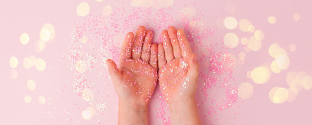 Kid child Hands with holding pink stars confetti sparkles. Flat lay style. Miracle, Tender fantasy...