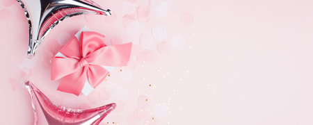 Holiday pink background with gift, luxury pink satin bow, ribbon.の写真素材