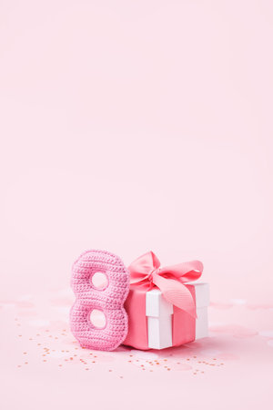 8 March, International Women's Day or Birthday concept. Figure eight of pink crochet with luxury...
