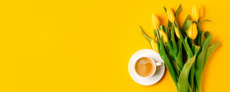 Coffee mug with bouquet of yellow tulips and copy space for notes good morning on bright yellow table, beautiful breakfast, vintage card, top view, flat lay, 8 march, woman day, mother day, romanceの写真素材