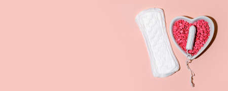 Menstrual tampon medical pad on pink background, top view, hard shadow, copyspace. Concept of choosing between protection treatment, tool for women to stop blood flow during menstrual period, bannerの写真素材