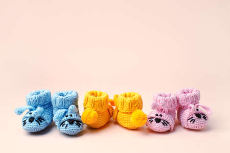 Set of small yellow baby socks on pastel background, copy space for your warm message, baby shower,...