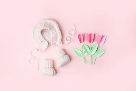 Pale pastel cute baby handknitted bonnet and booties socks. Set of kids clothes and accessories....