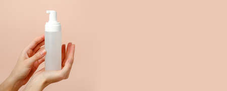 Pipette serum bottle dose of fluid hyaluronic acid with gel drops on neutral beige background. Cosmetics concept. Flat lay, copy space, dermatology beauty conceptの写真素材