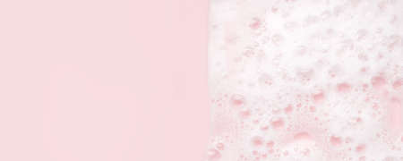 White foam bubbles texture on pink pastel background, copy space, banner for loundry, cleaning service, bathroom concept, clean, wash - liquid soap, shower gel, shampooの写真素材