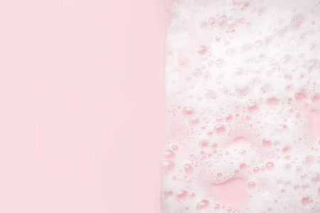White foam bubbles texture on pink pastel background, copy space, banner for loundry, cleaning service, bathroom concept, clean, wash - liquid soap, shower gel, shampooの写真素材
