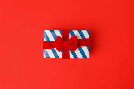 Blue white stripe gift box with red bowsの写真素材