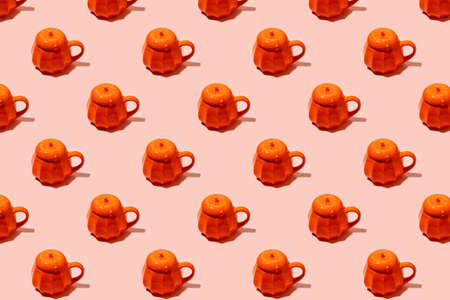 Ceramic Coffee tea soup cup as pumpkin on pink. Seamless pattern. Halloween concept, hard shadow,...