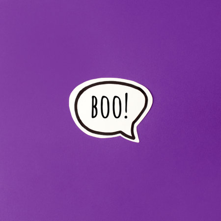 Halloween paper decorations chat bubble boo mock up on purple background. Flat lay, top view,...