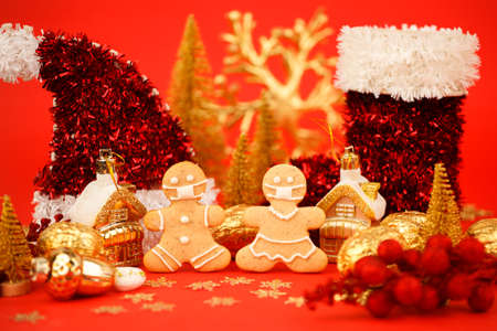 Happy New Year's 2022, Christmas set of gingerbread man and woman in face mask and red gold...