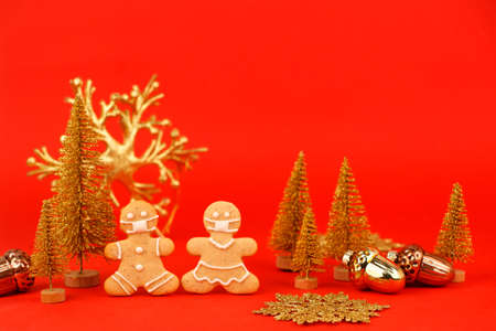 Happy New Year's 2022, Christmas set of gingerbread man and woman in face mask and red gold...
