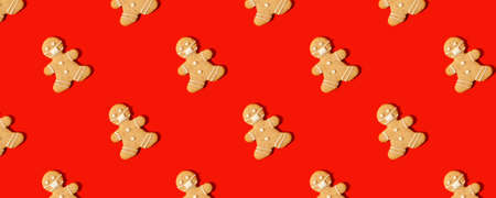 Happy New Year's 2022 banner gingerbread man in face mask from ginger biscuits on classic...
