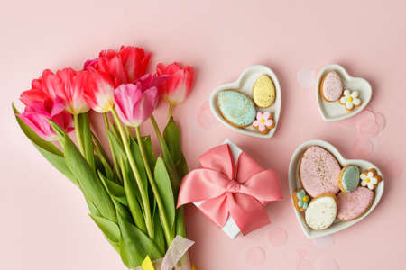 Easter floral background, various gingerbread glazed cookies end decorated with natural botanical elements on pink, flat lay, view from above, blank space for greeting text, banner, flyer, couponの写真素材