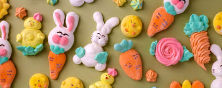 Colorful easter Sweet cookies, meringue on green background, colorful seasonal holiday concept,...