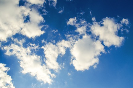 beautiful blue sky with white fluffy cloudsの写真素材