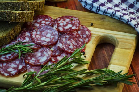 smoked sausage salami with lard and bread closeup