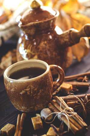 Tasty hot coffee with grains and spices on tableの写真素材