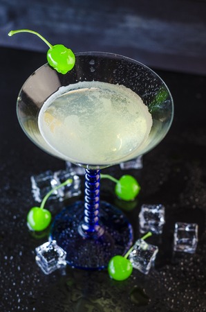 refreshing cocktail on a dark mirror table with iceの写真素材