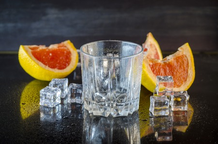 grapefruit drink with ice on a black backgroundの写真素材