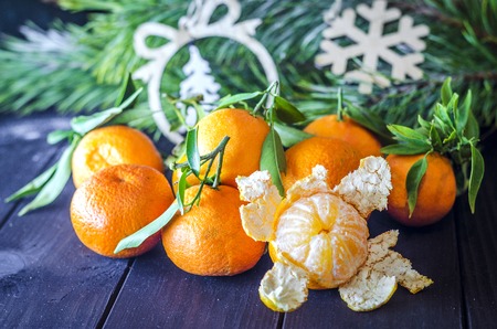 mandarins against the backdrop of a New Year decorated treeの写真素材