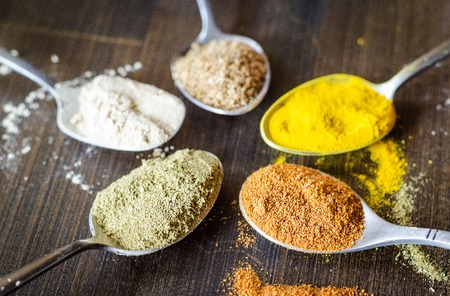 Set of different spices and spices in spoonsの写真素材