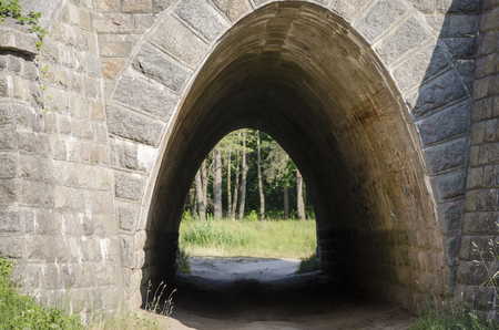 Small stone tunnel crossing under the railwayの写真素材
