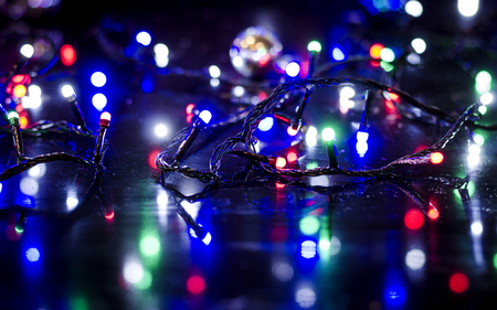 Christmas background, garland lights, holiday toys in blue