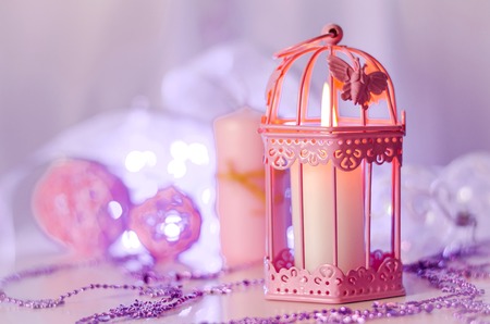 New Year and Christmas decoration with decorations and a candle lamp in pink colorの写真素材