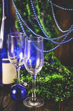 champagne glasses on a Christmas background near the Christmas treeの写真素材