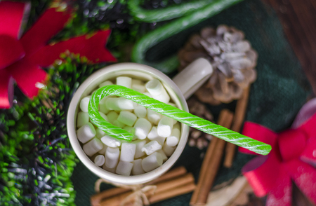 cup of drink with marshmallows on a new-year decorated backgroundの写真素材
