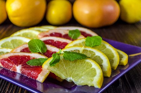 Citrus. Slices of fresh grapefruit and orange on a dishの写真素材