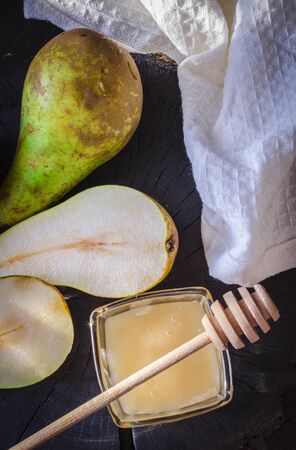 fresh pears and honey on the tableの写真素材