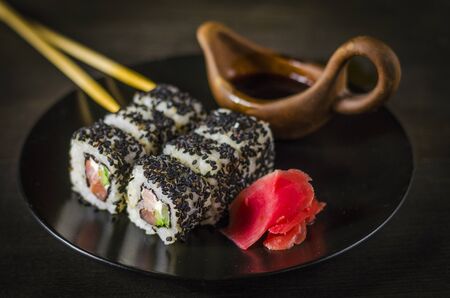 sushi rolls in black sesame on a dishの写真素材